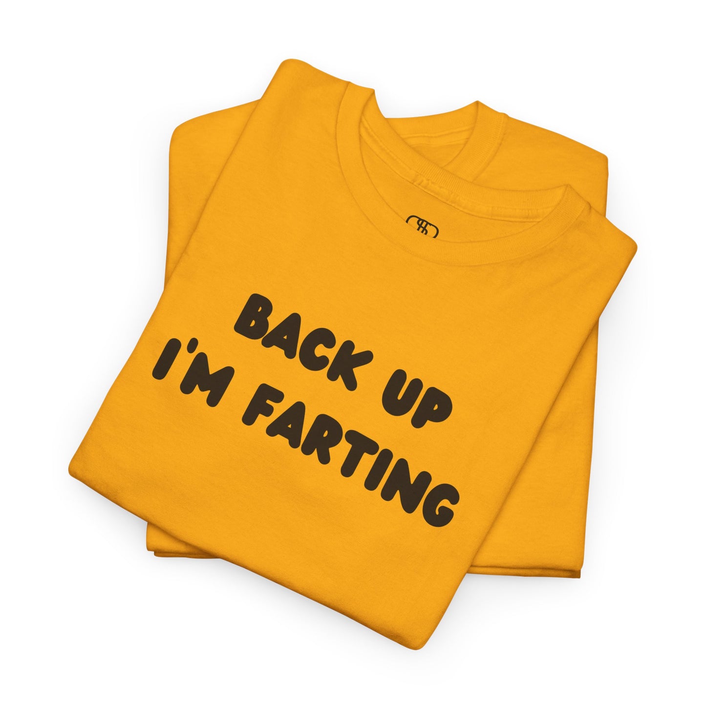 A folded Gold T-shirt with the bold text "Back Up I'm Farting" on the front.