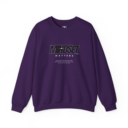 A purple sweater "Mindset Matters" text with stars on a sweater, inspirational quote below the main quote. 