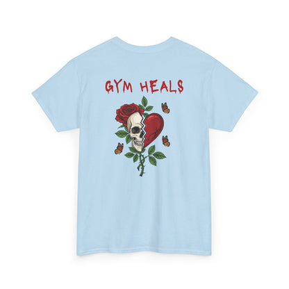 A light blue t-shirt with a front design of a half skull, half broken heart, and a rose. The back reads "Gym Heals" in red.