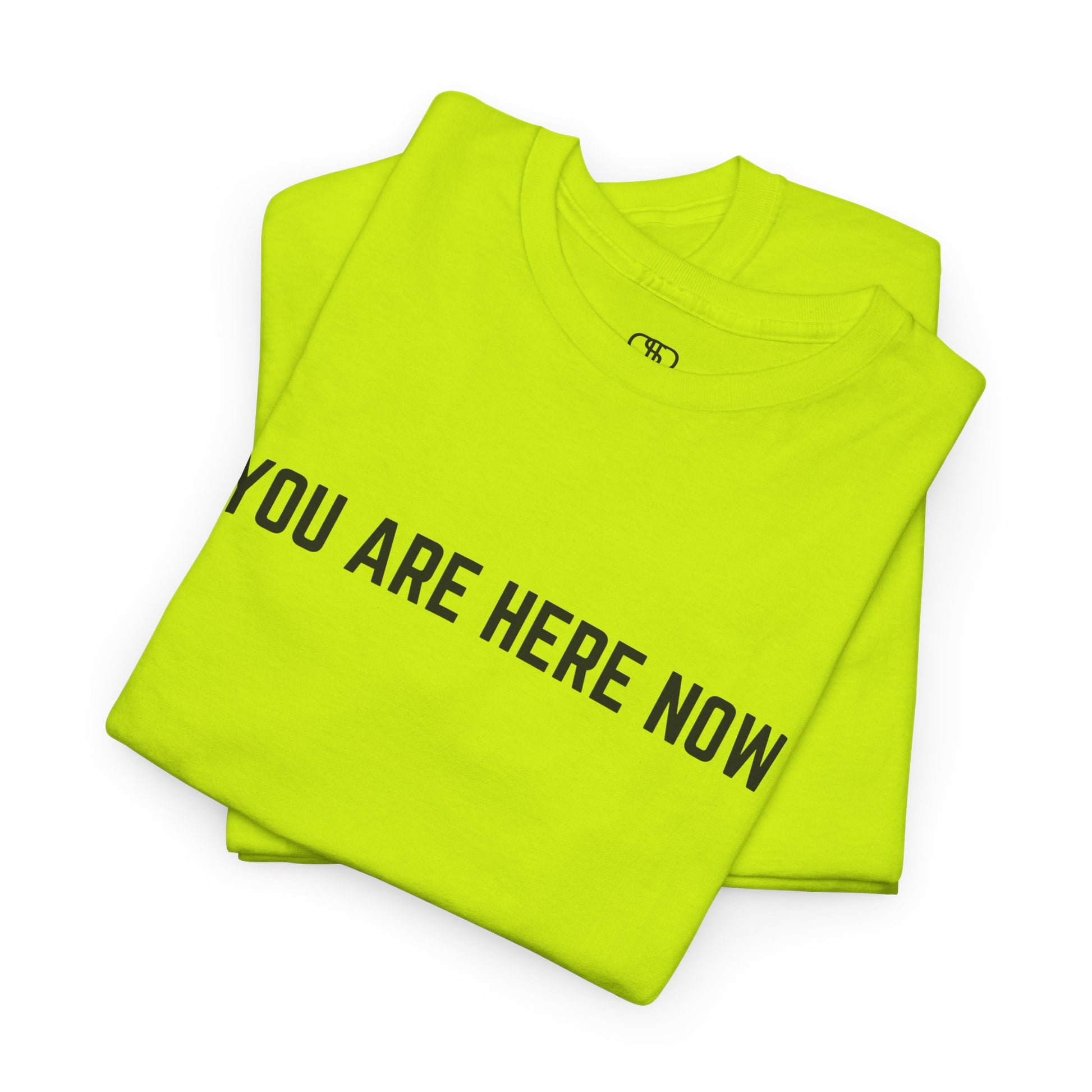 A folded safety green t-shirt with the words "You are Here Now." 
