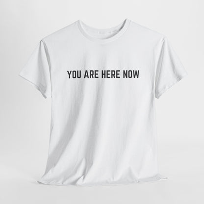 Front of a t-shirt with the grounding phrase "You are Here now" in a clean, minimalist font.