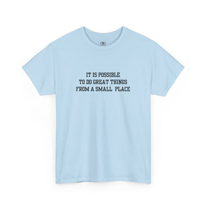 A light blue t-shirt with the quote “It is possible to do great things from a small place” on the front.