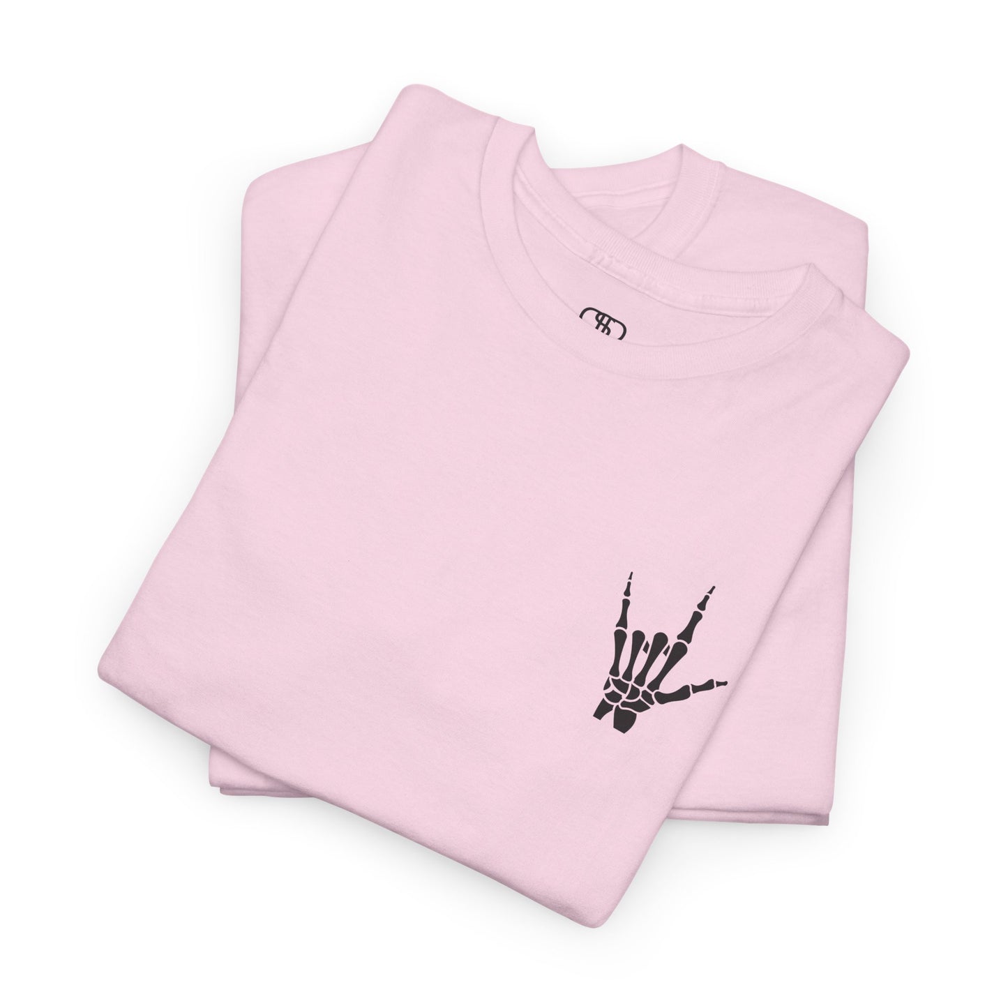 A folded light pink t-shirt with small rock hand symbol on front, and "Rules.. Never Heard of Them" graffiti text on the back.