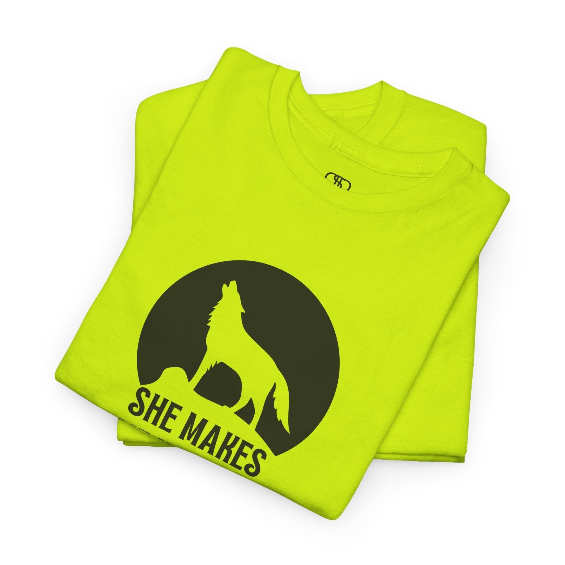 A folded safety green T-shirt with a wolf silhouette howling at the moon on a cliff, and "She makes me HOOWWL" text.