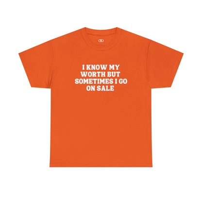 A [orange] t-shirt with the funny quote "I know my worth but sometimes I go on sale" printed in a clean, black font across the chest.