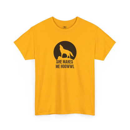 A gold T-shirt with a wolf silhouette howling at the moon on a cliff, and "She makes me HOOWWL" text.