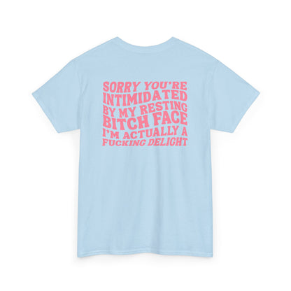 A light blue t-shirt with a skeletal hand in a bubble on the front and the phrase “Sorry you’re intimidated by my resting Bitch ace I’m actually a fucking delight” on the back.