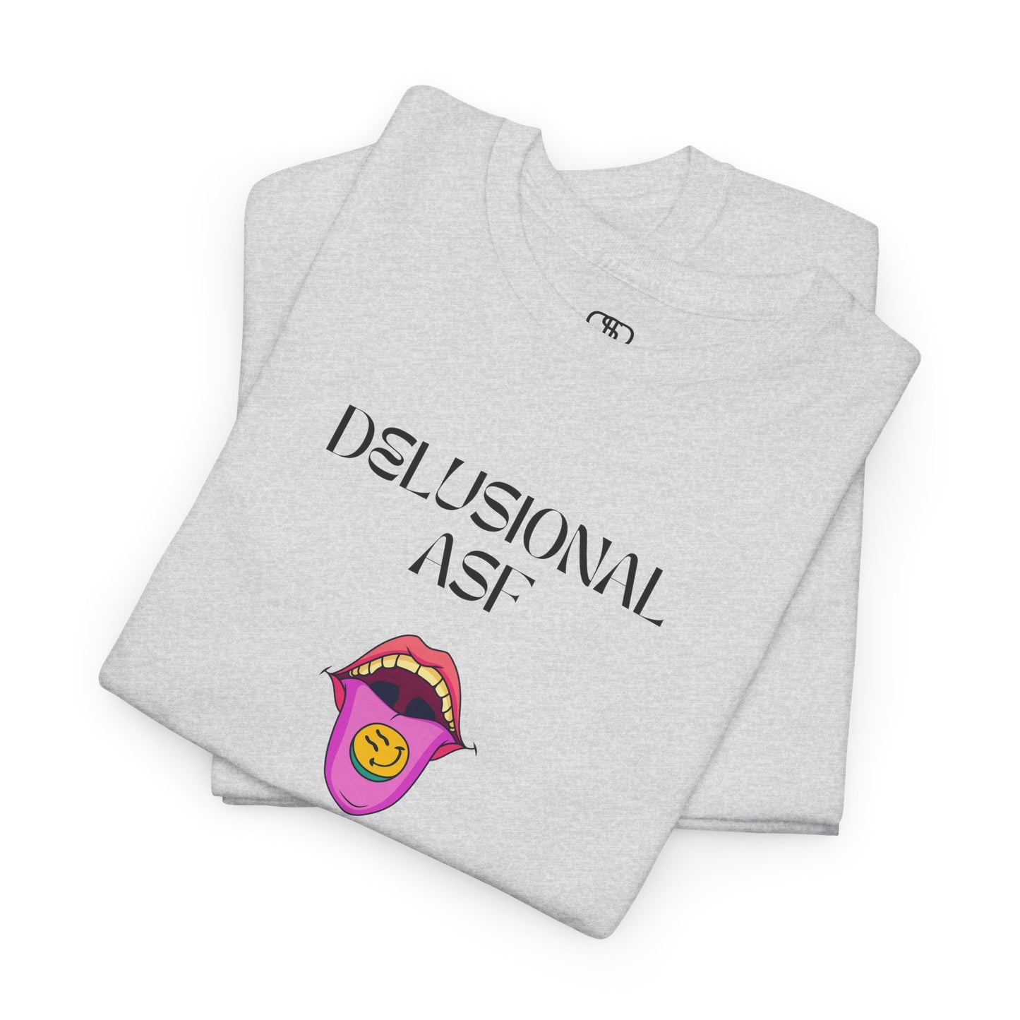 A folded ash gray T-shirt with "Delusional asf" text, an open mouth graphic with tongue out, and a happy face emoji pill.