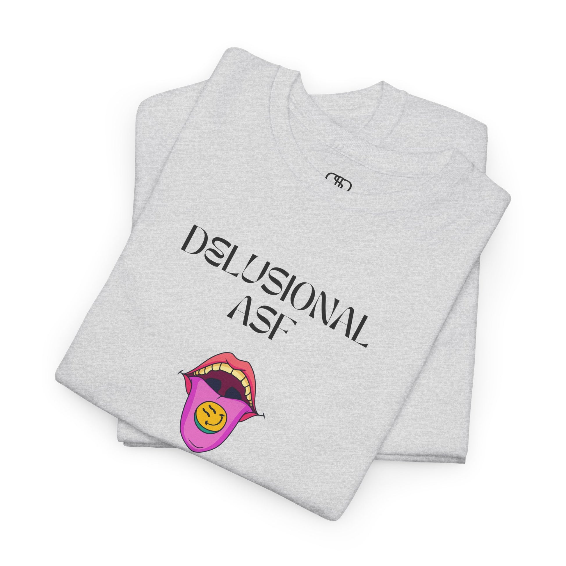 A folded ash gray T-shirt with "Delusional asf" text, an open mouth graphic with tongue out, and a happy face emoji pill.