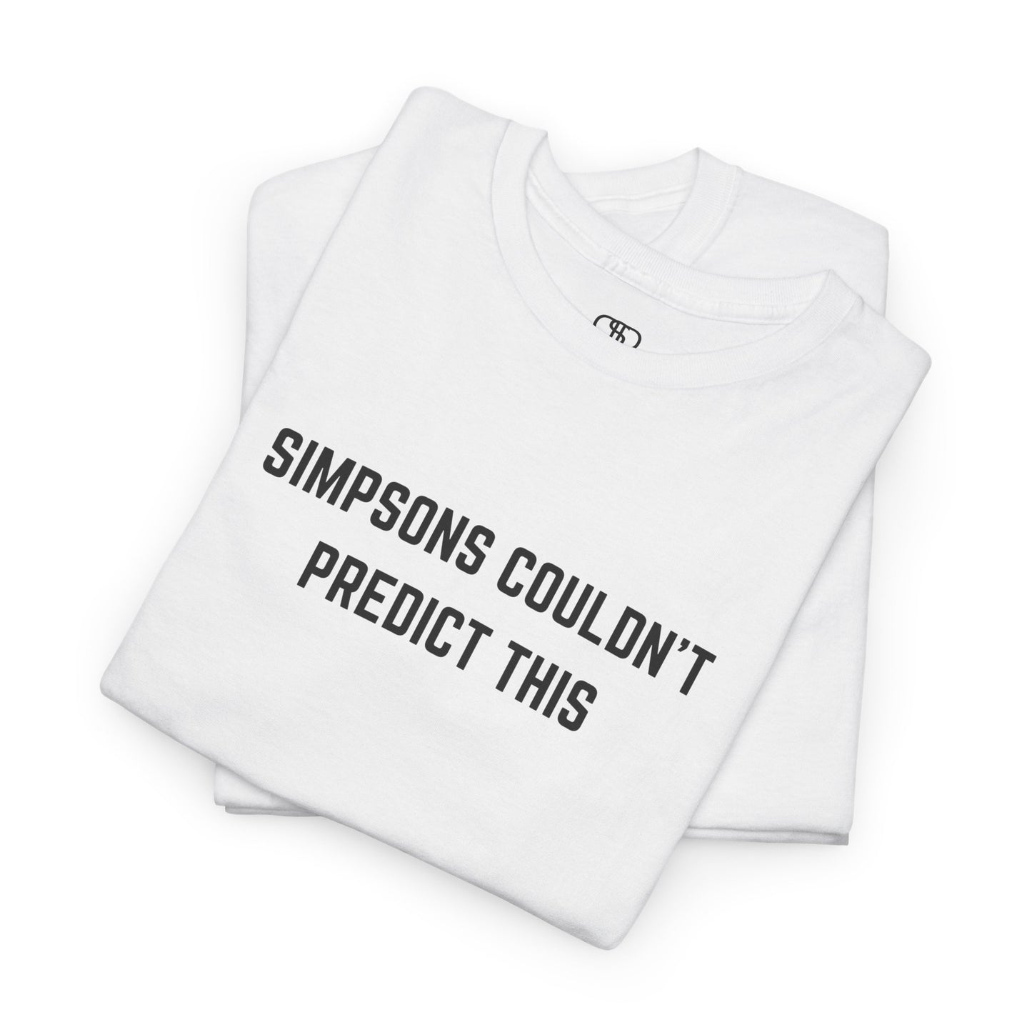 A folded white T-shirt with the text "Simpsons Couldn't Predict This."
