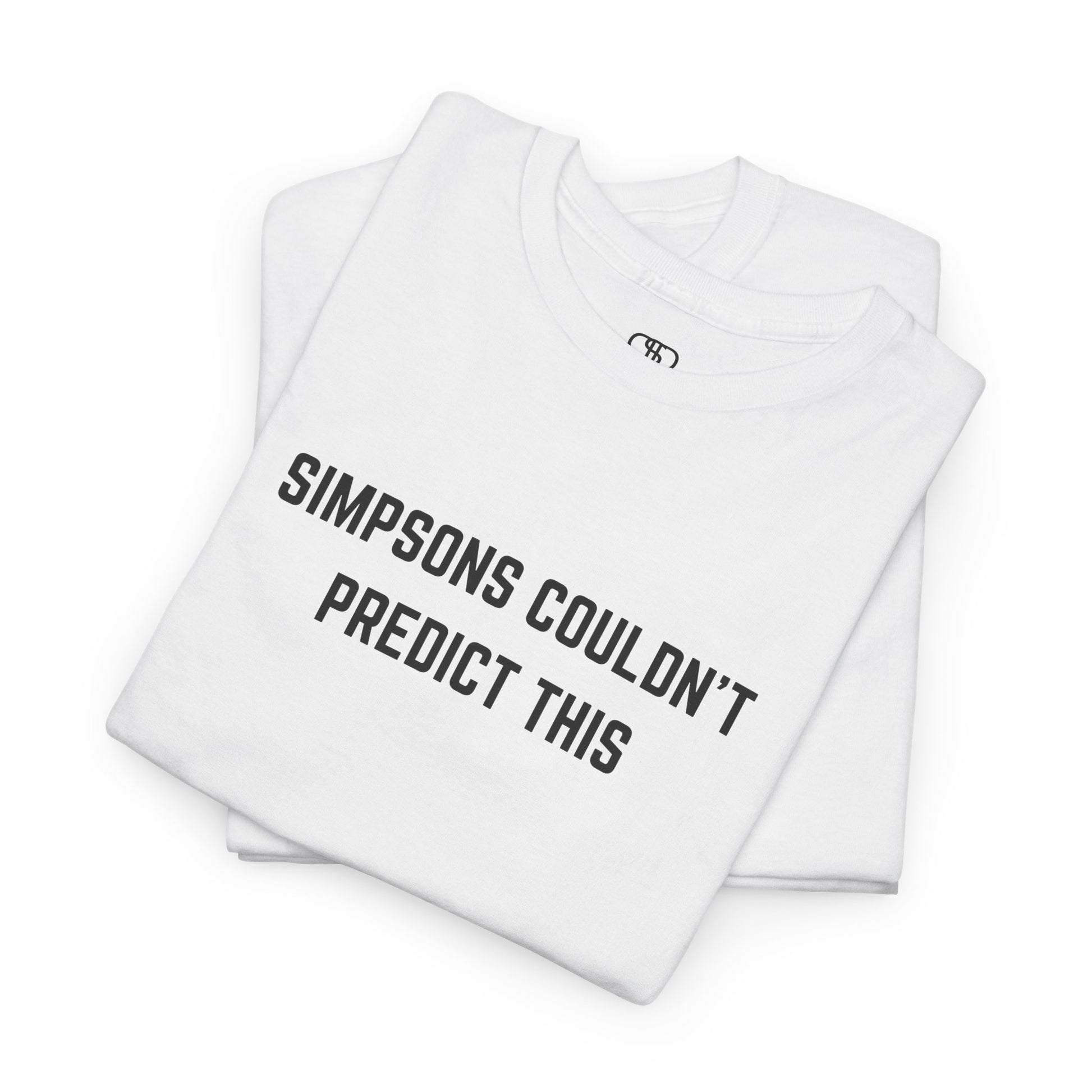A folded white T-shirt with the text "Simpsons Couldn't Predict This."
