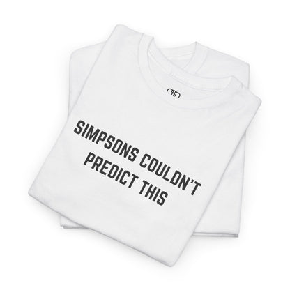 A folded white T-shirt with the text "Simpsons Couldn't Predict This."
