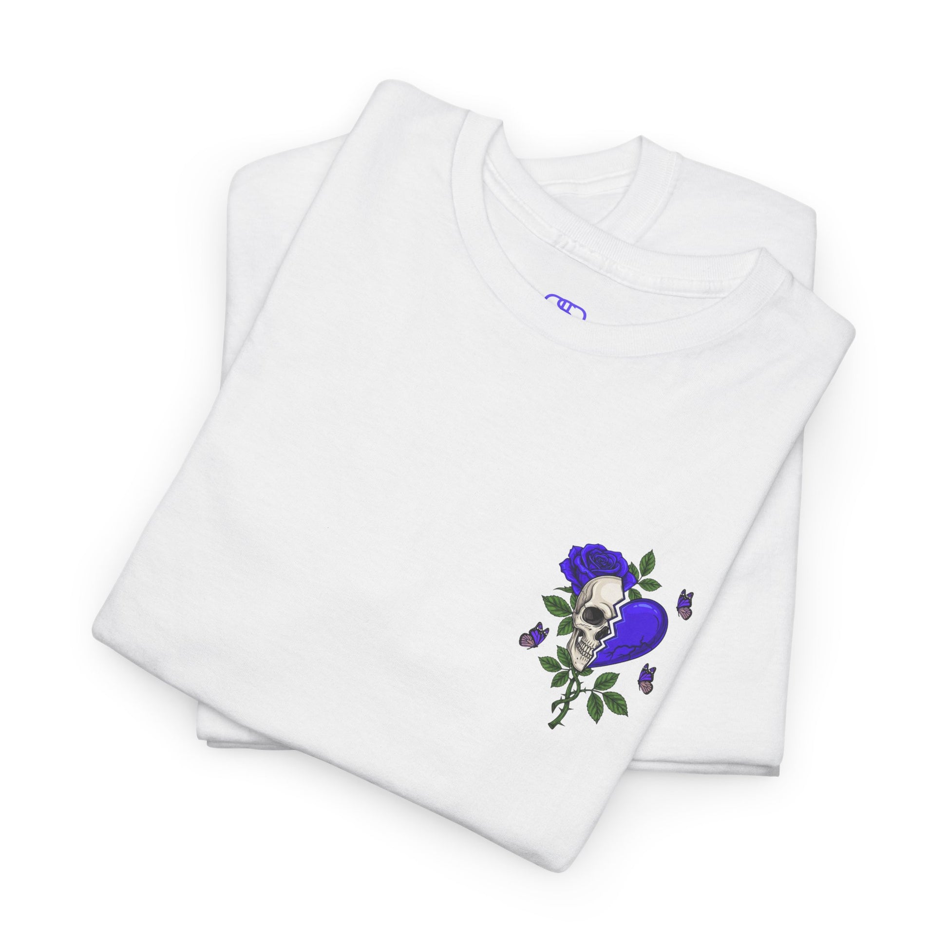 A folded white t-shirt with a front design of a half skull, half broken purple heart, and a rose. The back reads "Gym Heals" along with a similar design found on the front.