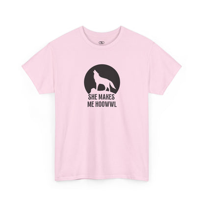 A light pink T-shirt with a wolf silhouette howling at the moon on a cliff, and "She makes me HOOWWL" text.