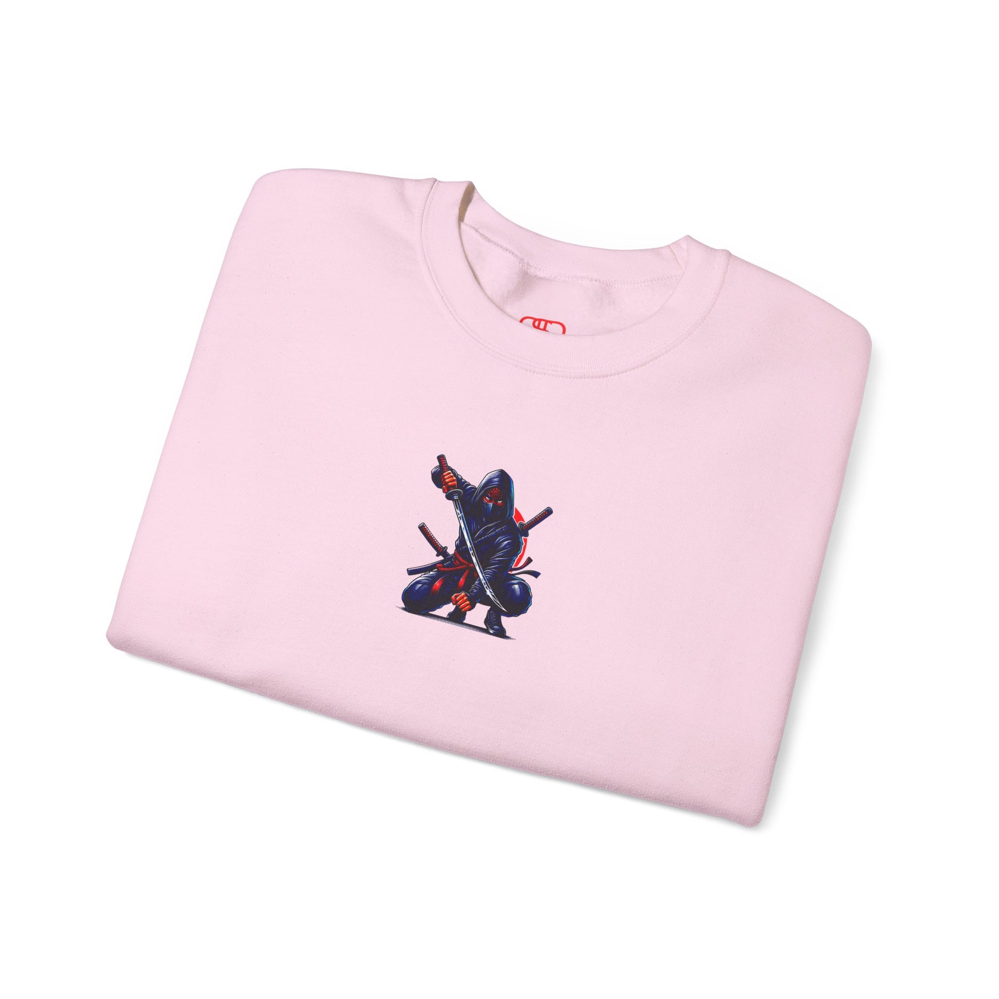 A light pink folded sweatshirt featuring a Crouching ninja with two katanas and "Bushido" text, red and black Japanese-inspired sweatshirt design.