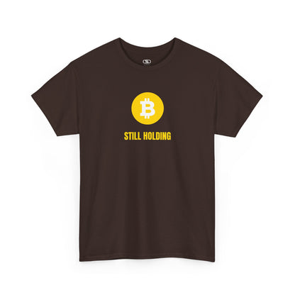 A dark brown  T-shirt with a Bitcoin emblem and "Still Holding" text in gold.