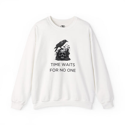 A sweatshirt featuring a detailed illustration of a crow perched on a human skull that is intertwined with overgrown vines and moss. Along with the words Time Waits For No One. 