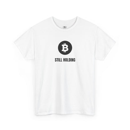A white T-shirt with a Bitcoin emblem and "Still Holding" text in black.