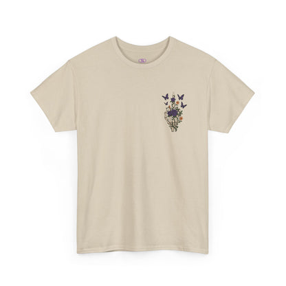 A sand t-shirt with a skeleton hand flipping its middle finger on the front surrounded by vines, roses, & butterflies, and a full skeleton design on the back with the phrase “My Last Flying Fuck.”