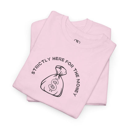 A folded light pink T-shirt with curved text "Strictly here for the money" and a money bag graphic underneath.
