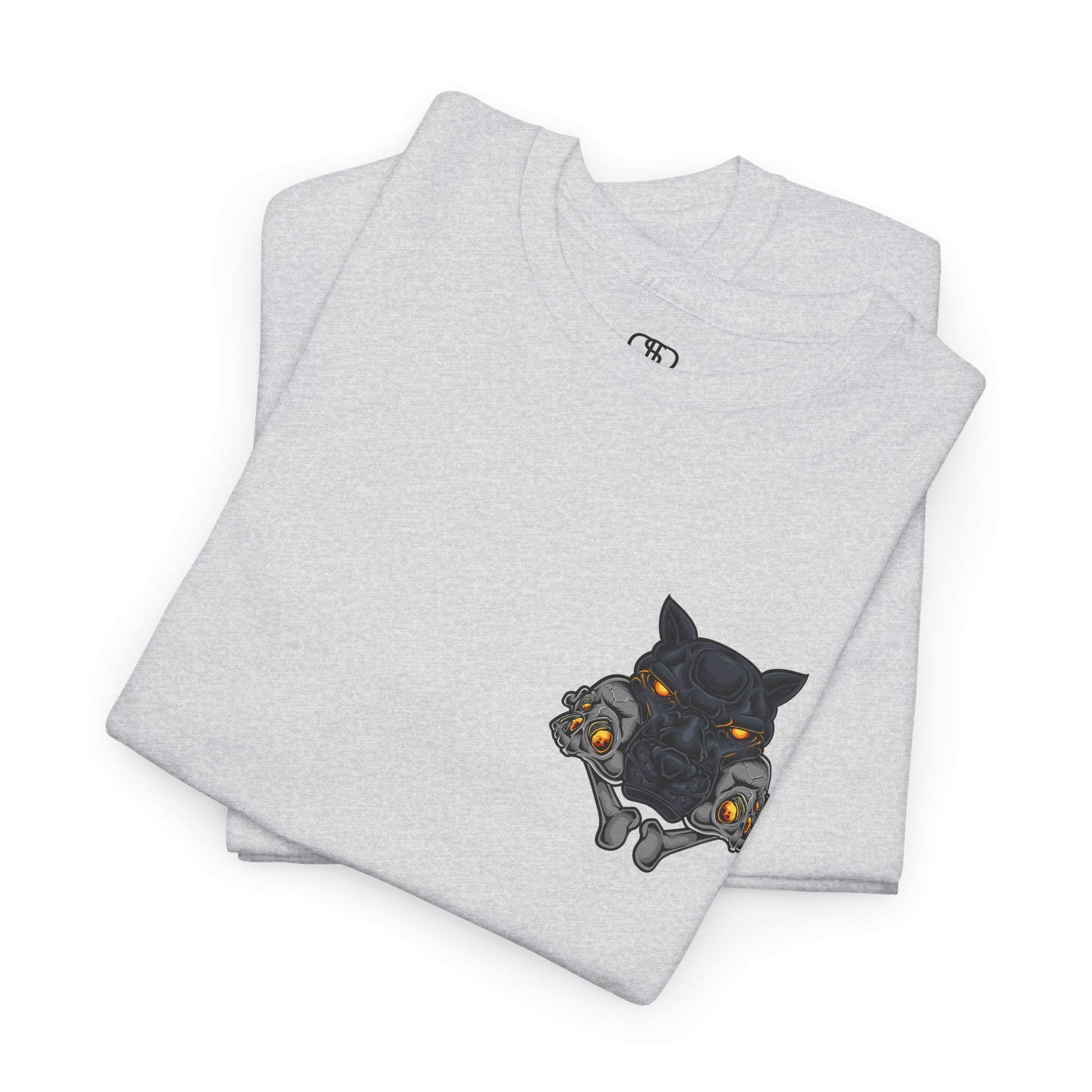 A folded ash gray T-shirt with a daring dog graphic biting two skulls, all with glowing molten lava-like eyes.