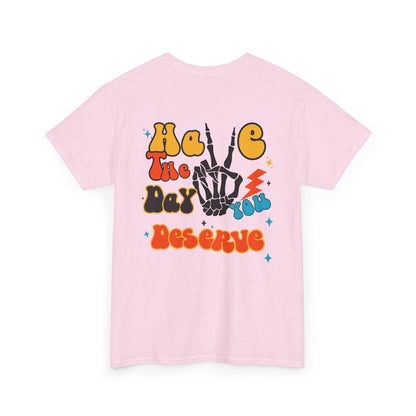 A [light pink] t-shirt with a skeletal peace sign on the front and the phrase “Have the day you deserve” with a large skeletal peace sign on the back.