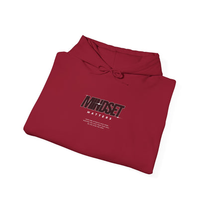 A folded garnet red hoodie "Mindset Matters" text with stars on hoodie, with an inspirational quote below.