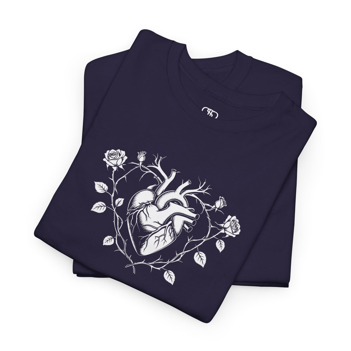 A folded t-shirt with a heart surrounded by thorn vines, red roses, and green leaves graphic.