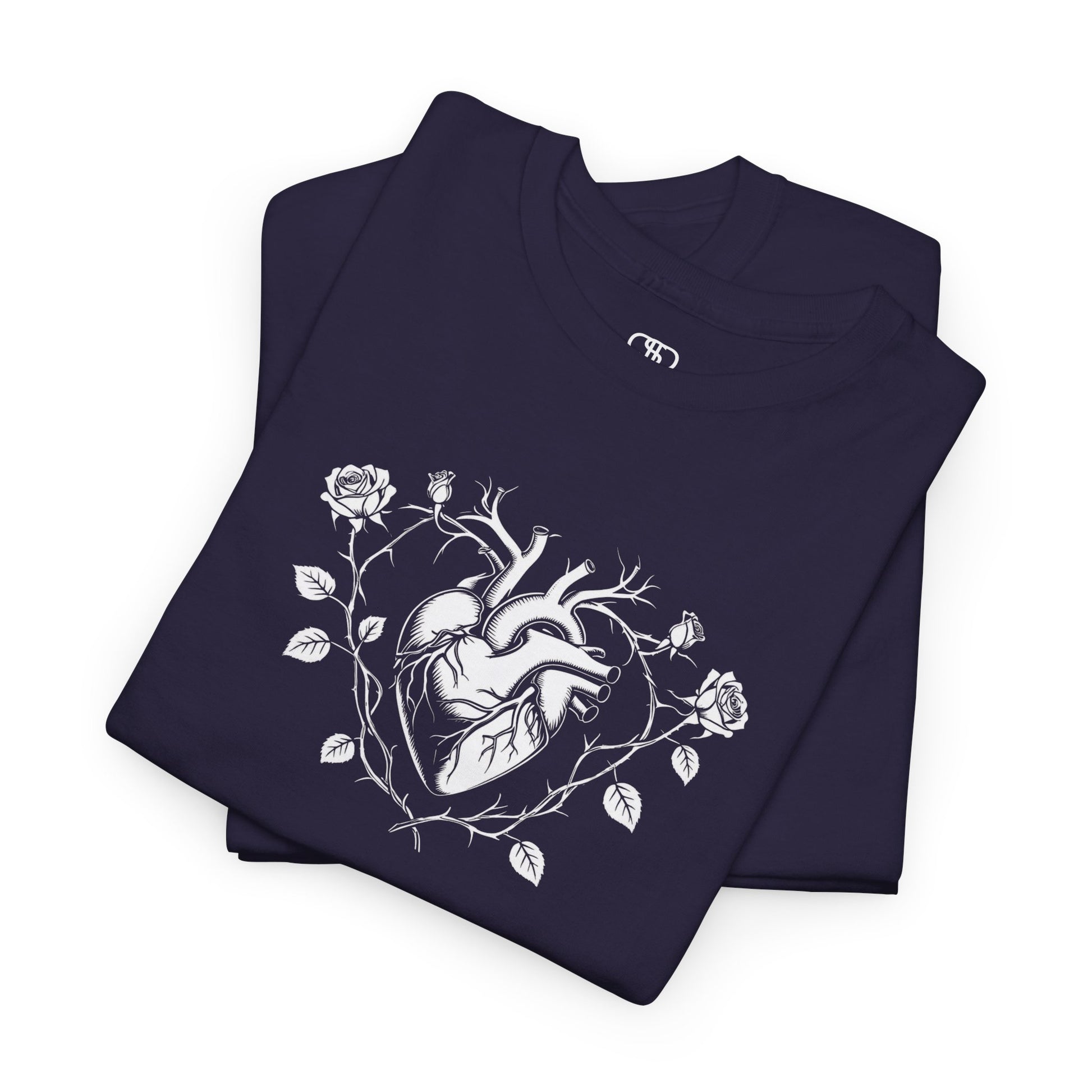 A folded t-shirt with a heart surrounded by thorn vines, red roses, and green leaves graphic.