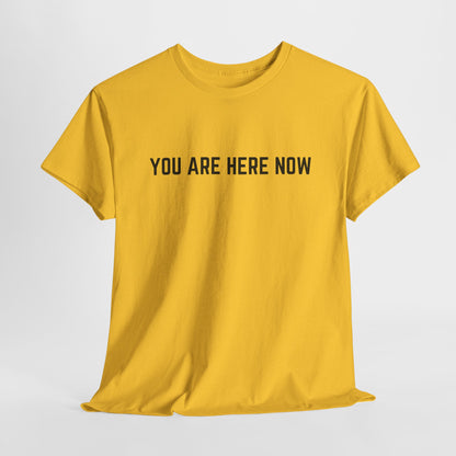 Front of a t-shirt with the grounding phrase "You are Here now" in a clean, minimalist font.