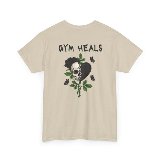 A t-shirt with a front design of a half skull, half broken heart, and a rose. The back reads "Gym Heals" in black.