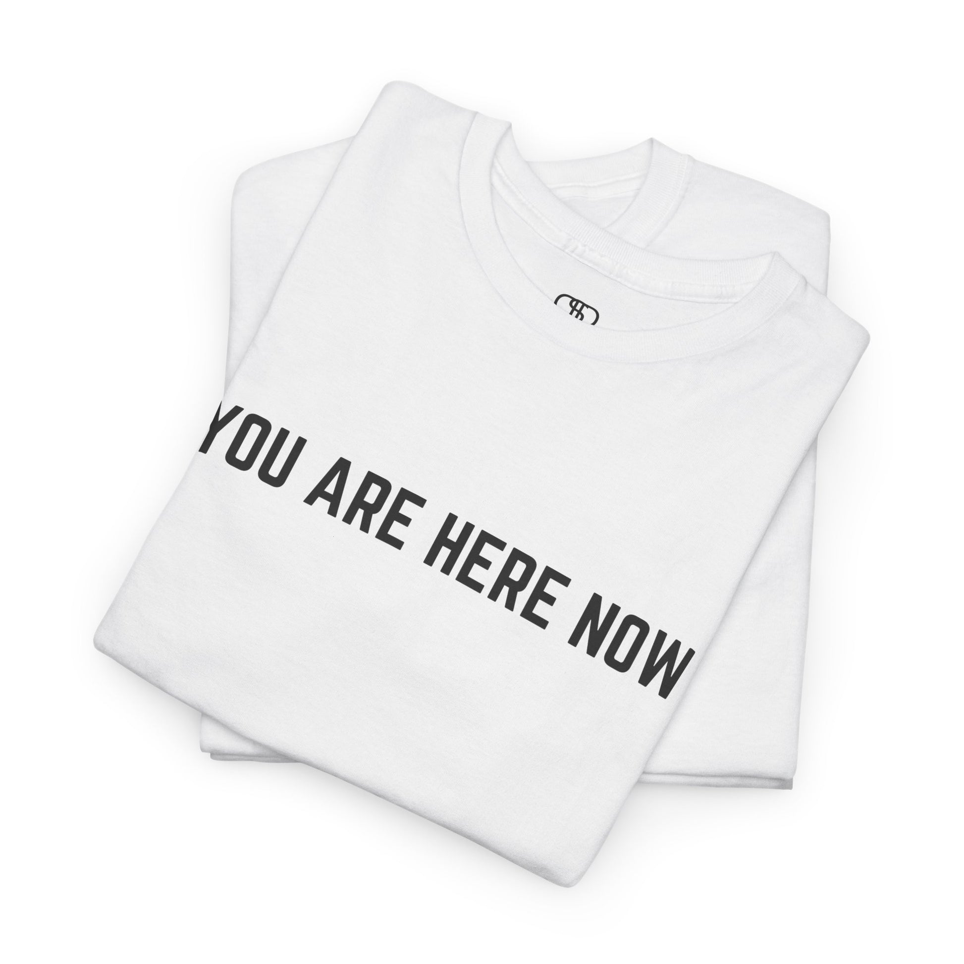 Front of a t-shirt with the grounding phrase "You are Here now" in a clean, minimalist font.