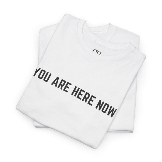 Front of a t-shirt with the grounding phrase "You are Here now" in a clean, minimalist font.
