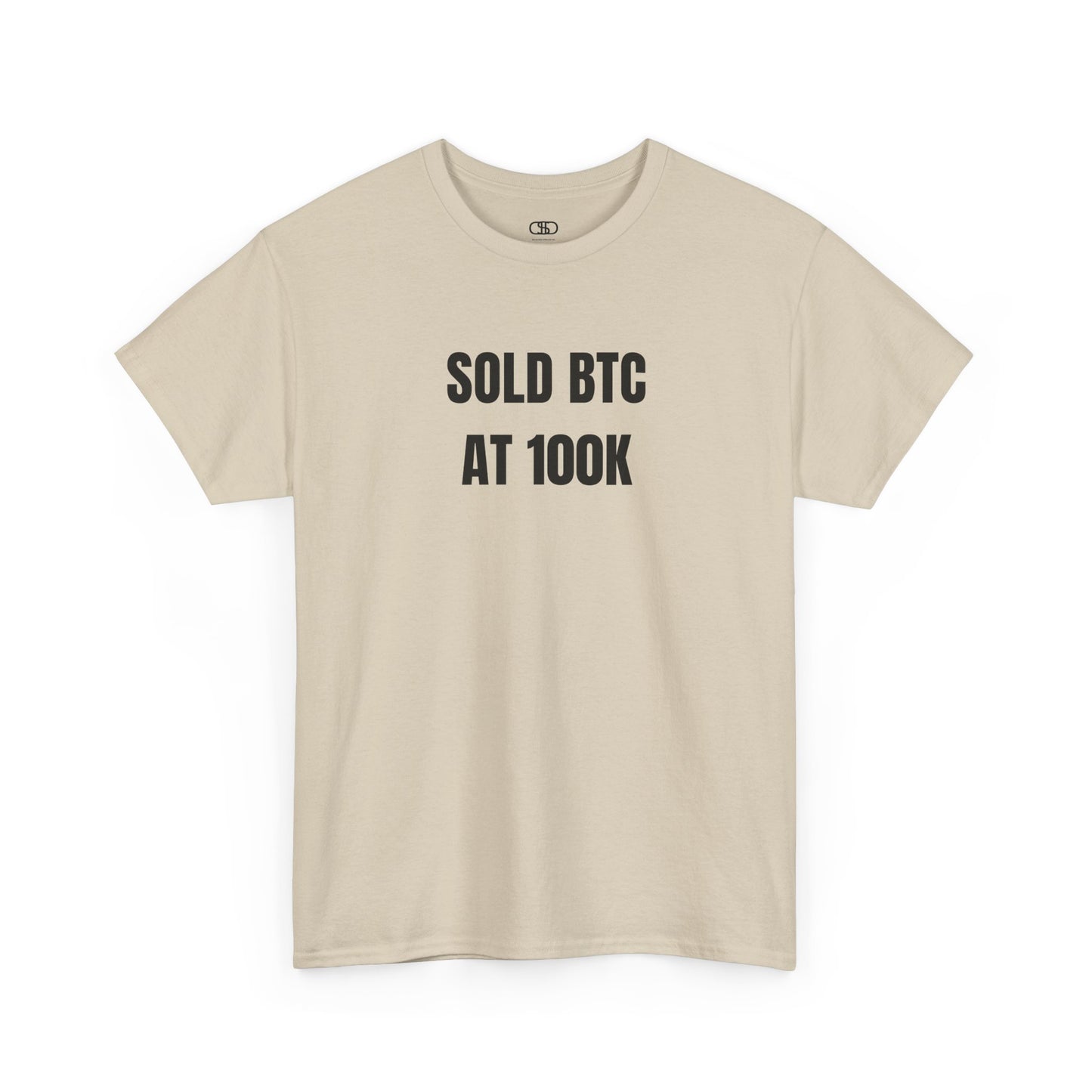 A sand T-shirt with bold text "SOLD BTC At 100K" on the front.
