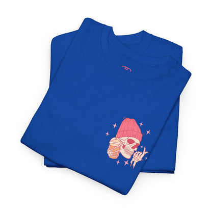 A ROYAL bLUE FOLDED T-shirt with a skeleton in a pink beanie holding a frozen coffee, snapping fingers, surrounded by sparkles graphic.
