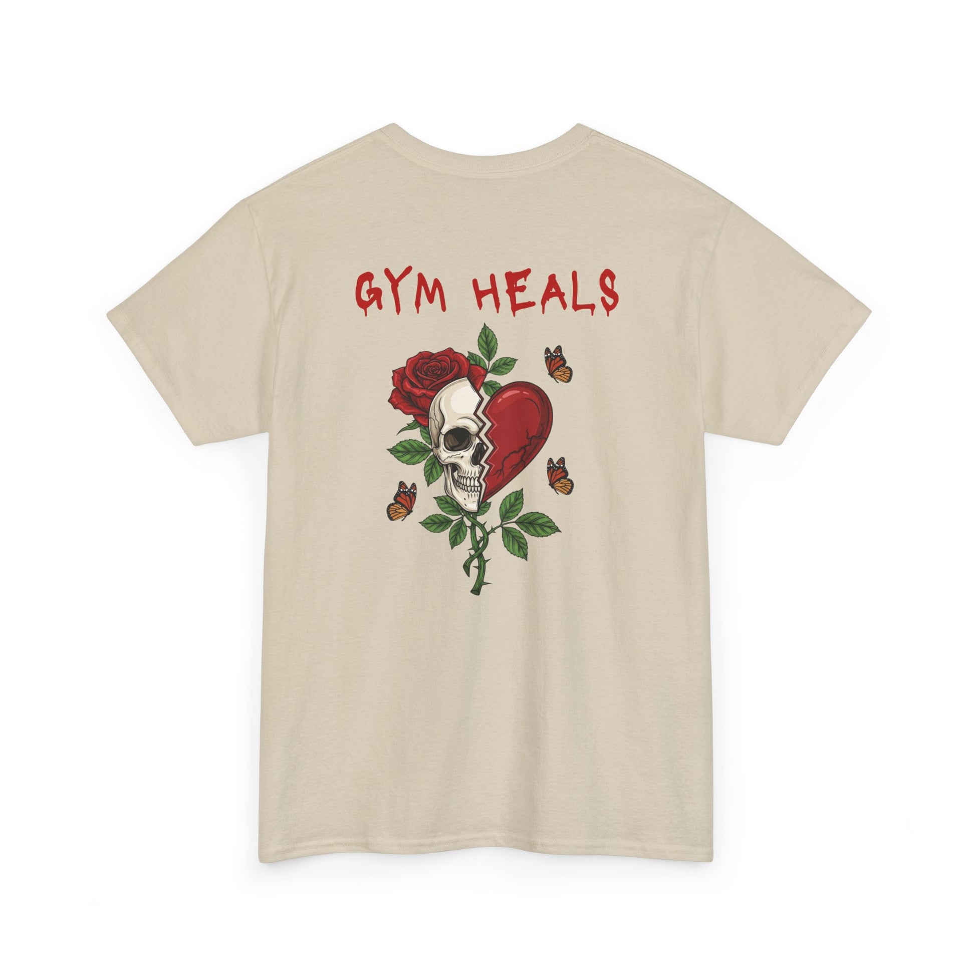 A sand t-shirt with a front design of a half skull, half broken heart, and a rose. The back reads "Gym Heals" in red.
