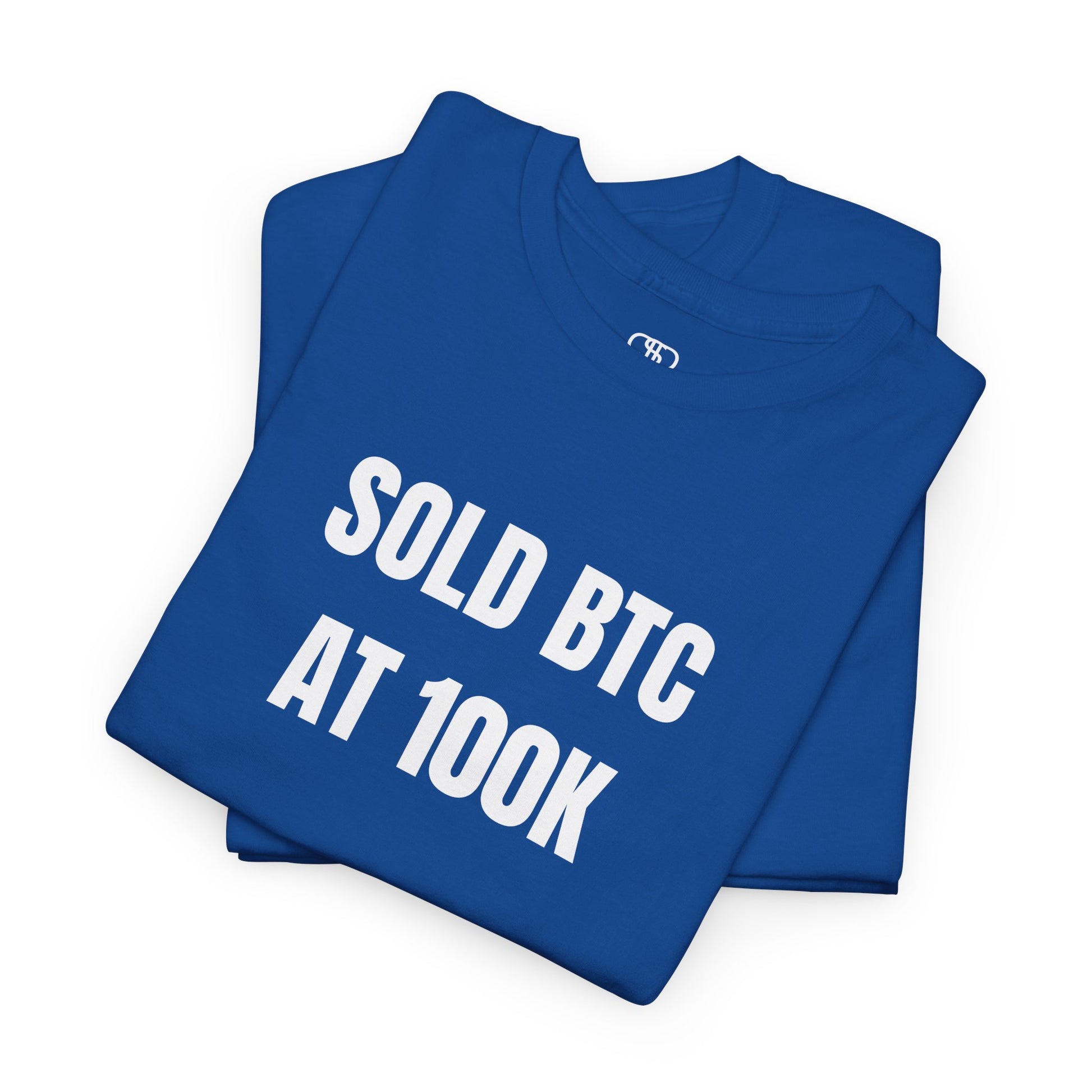 A folded Royal Blue T-shirt with bold text "SOLD BTC At 100K" on the front.