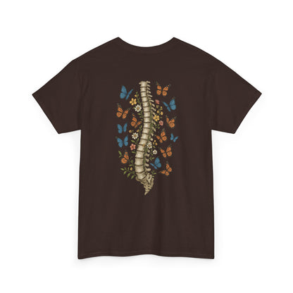 A dark brown t-shirt with "Grow Through It" and a butterfly on the front and a design of a spine with vines, flowers, and butterflies on the back.