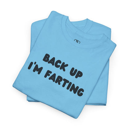 A folded sky blue T-shirt with the bold text "Back Up I'm Farting" on the front.