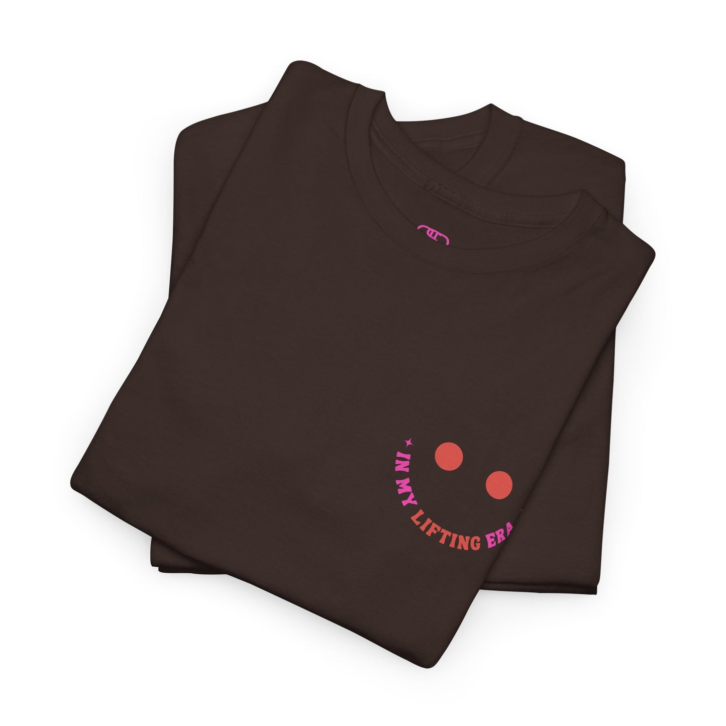 A folded dark brown t-shirt with a retro smiley face on the front and the phrase “In my lifting Era” in a creative retro design on the back.