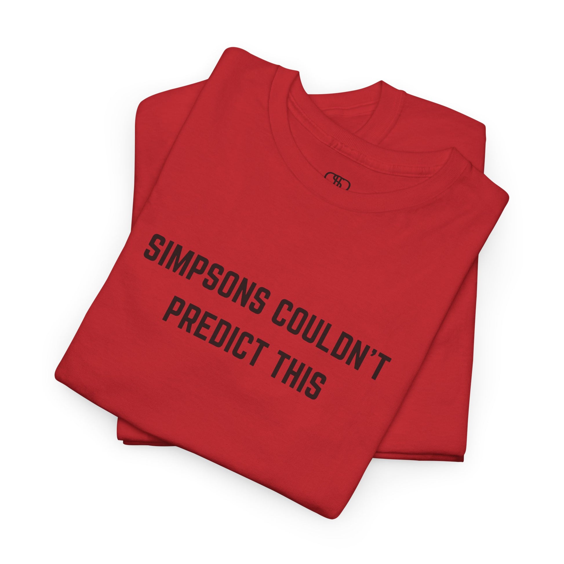 A folded red T-shirt with the text "Simpsons Couldn't Predict This."

