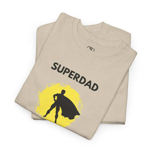 A sand colored T-shirt with a "Superdad" text and a silhouette of a person with a cape on a yellow circle background.
