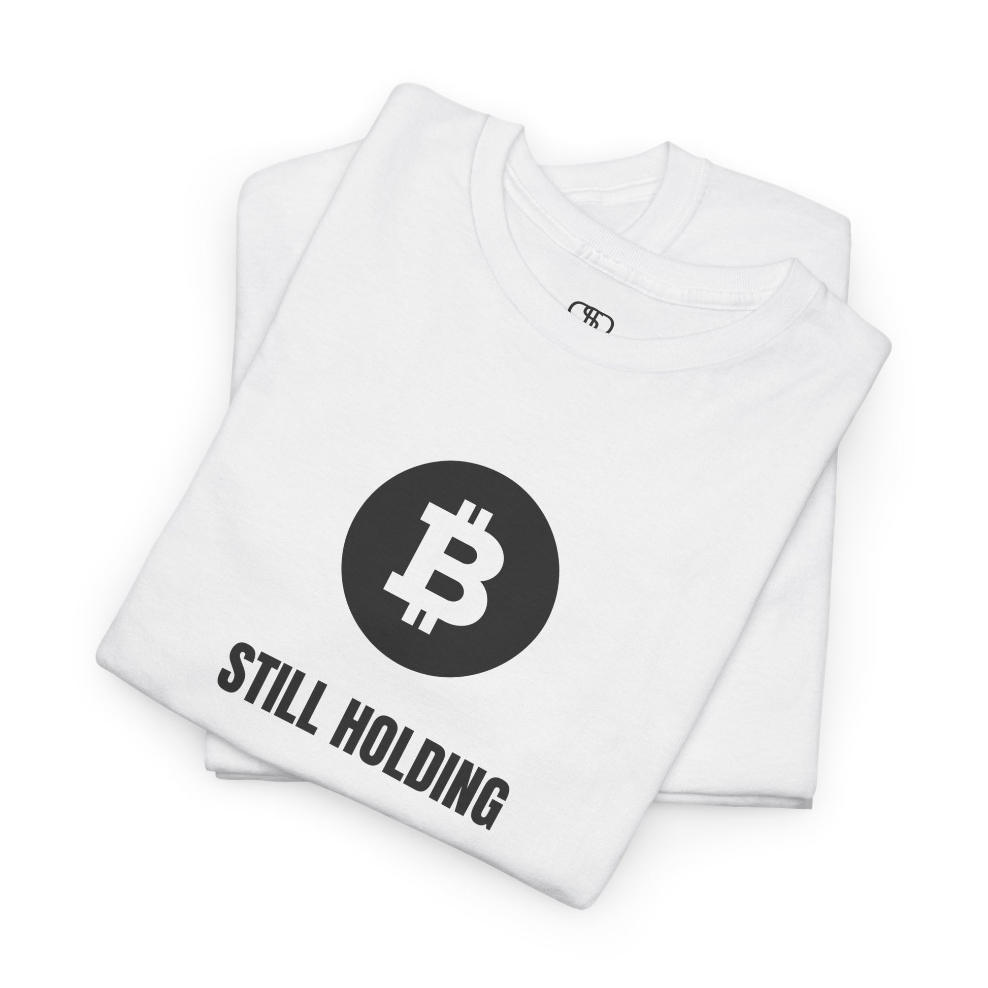 a FOLDED WHITE T-shirt with a Bitcoin emblem and "Still Holding" text in black.