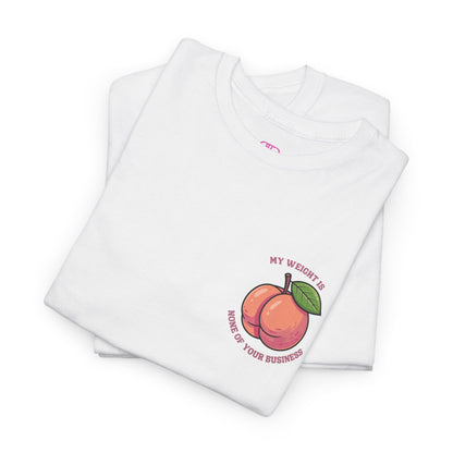 A folded white t-shirt with a peach and the words “My Weight is None of your Business” on the front and the full phrase in a retro font on the back.