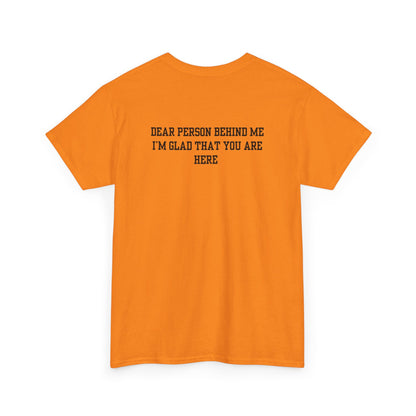 A folded orange t-shirt with a smiling sunflower and the words “Make the best out of Everyday” on the front and “Dear Person behind me, I’m glad that you are here” on the back.