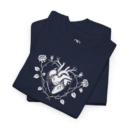 A FOLDED  t-shirt with a heart surrounded by thorn vines, red roses, and green leaves graphic.