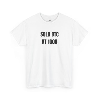A white T-shirt with bold text "SOLD BTC At 100K" on the front.