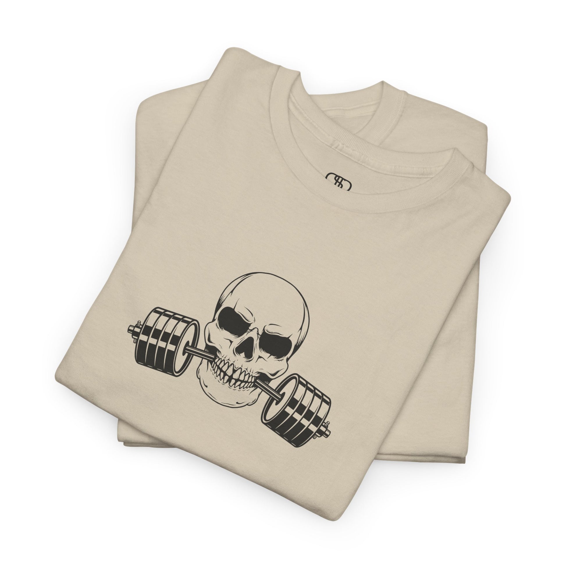 A folded t-shirt in [sand color] with a skull biting a barbell and the words “Be Stronger Than Your Excuses.”