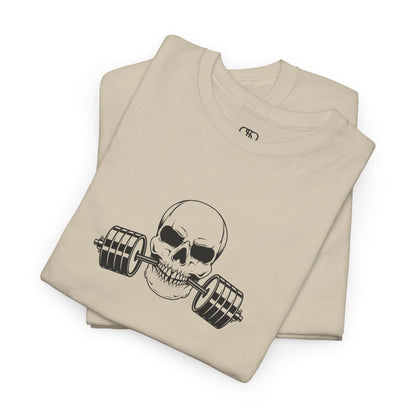 A folded t-shirt in [sand color] with a skull biting a barbell and the words “Be Stronger Than Your Excuses.”