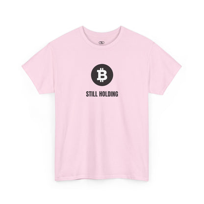 A LIGHT PINK T-shirt with a Bitcoin emblem and "Still Holding" text in black.